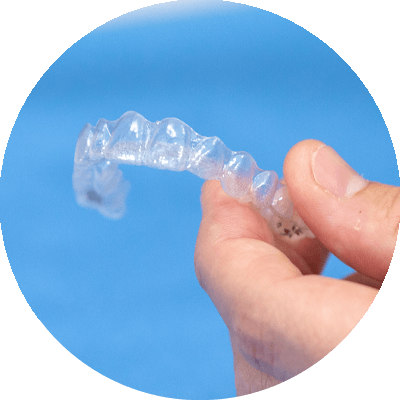 invisalign retainer held by orthodontics patient