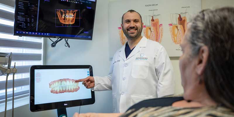 Doctor Basar with a patient during a dental implants consultation