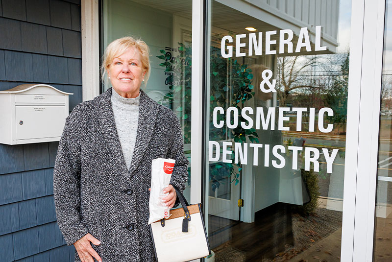 Patient smiling standing outside dental office